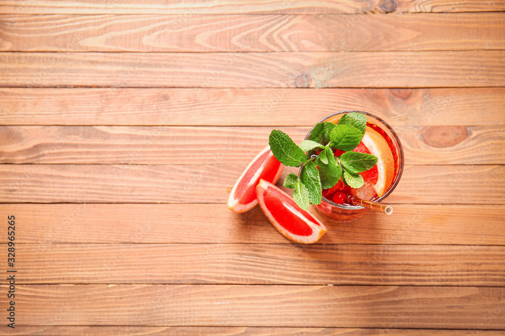 Glass of cold tea on wooden table