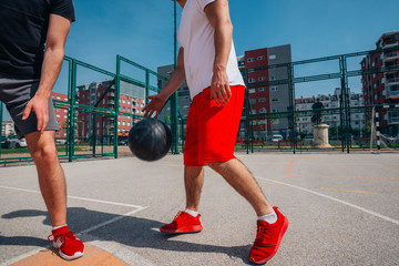 Wall Mural - Two street basketball players playing one on one lot of close up action and guarding the ball.