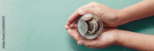 Photographie child hands holding money jar, donation, saving, charity, family finance plan c