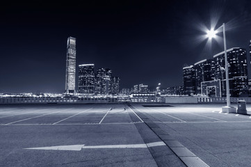 Poster - empty car park with city skyline background