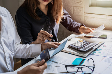 stressed young couple checking bills, taxes, bank account balance and calculating expenses in the li