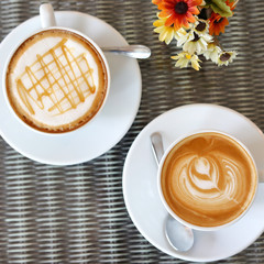 hot caramel macchiato and latte coffee drink put on table in cafe