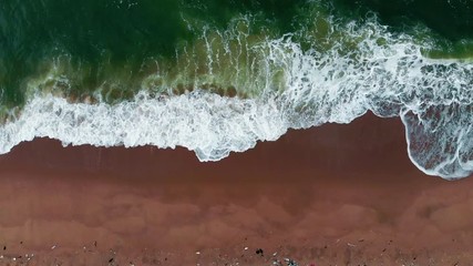 Wall Mural - Tropical beach water background. Soft wave of emerald clear sea on sandy beach