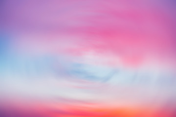 Wall Mural - beautiful backdrop of sunset sky with pink orange light clouds in blue sky. colorful smooth dawn sky