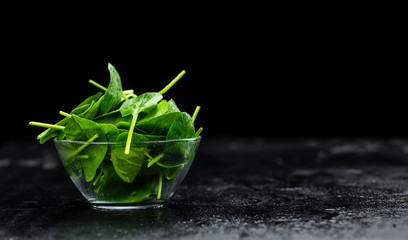 Wall Mural - Spinach on a vintage background (close-up; selective focus)