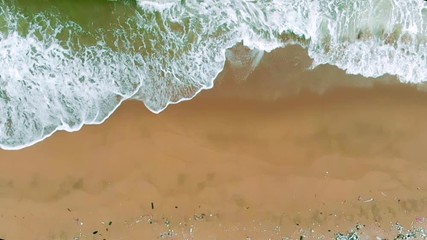 Wall Mural - Tropical beach water background. Soft wave of emerald clear sea on sandy beach