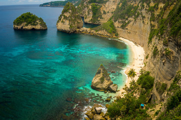 Wall Mural - beautiful aerial view of tropical paradise beach and rock cliff with amazing turquoise sea water and palm trees in Summer holidays travel destination and exotic vacations trip