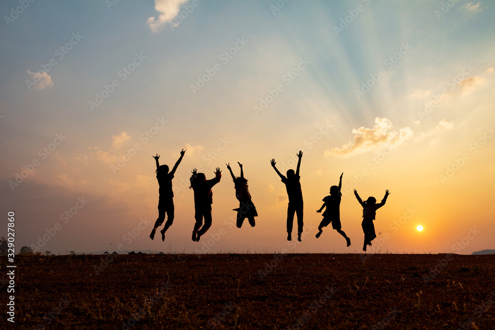 Silhouette group of happy children jumping playing on mountain at ...