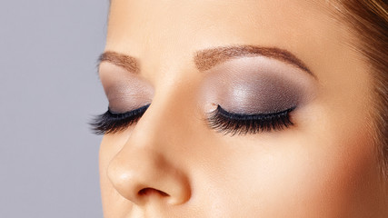 Woman eyes with long eyelashes and smokey eyes make-up. Eyelash extensions, makeup, cosmetics, beauty