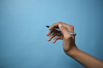 Man Holding Pen Or Pencil isolated on Clear Blue Background