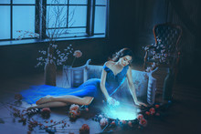 Fantasy Young Sorceress Woman In Long Blue Dress Touch Divine Old Mirror. Predictor Future Fairy Tale Snow White. Magic Power Of Wind Light Spell. Mystic Gothic Art Photo In Dark Black Medieval Room
