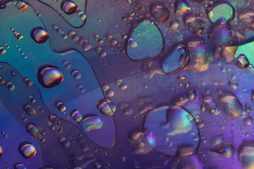 Beautiful abstraction violet color light water drop of holographic effect. Background pattern for design. Macro photography view.