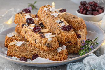 Wall Mural - Granola bar. Healthy snack. Cereal granola bar with nuts, fruit, coconut and cranberries on a christmas table