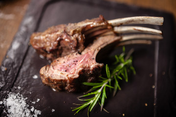 Grilled lamb chops served with a branch of rosemary