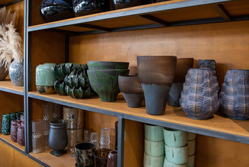 Wall Mural - A variety of beautiful flower pots and vases on the shelves of the greek flower boutique in spring.