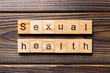 © sosiukin - Sexual health word written on wood block. Sexual health text on table, concept