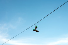 Sneakers Hung On An Electric Cable