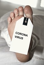Dead Body In Morgue With Identification Sign On Thumb. This Person Has Died From Corona Infection With Covid 19.Dead Body In Morgue With Identification Sign On Thumb. This Person Has Died From Corona 