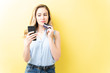© AntonioDiaz - Woman Doing Online Shopping Through Mobile Phone