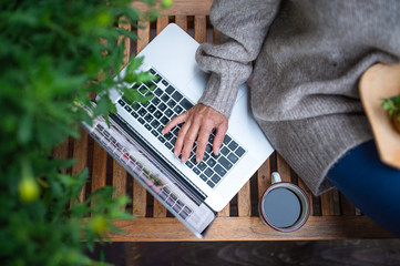 Wall Mural - Top view of senior woman with laptop sitting outdoors on terrace, working.