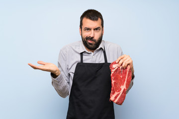 Wall Mural - Chef holding a raw meat unhappy for not understand something