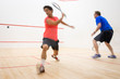 © lightpoet - Squash players in action on a squash court (motion blurred image; color toned image)