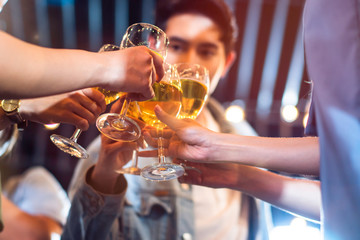 Group of beautiful Asian friendship people celebrating at rooftop party together, gang of best friend having cheerful drink and dance in music fun night lifestyle with light flare and bokeh background