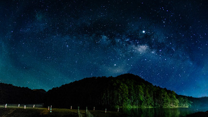 Fototapete - Milky way galaxy with stars and space in the universe background at thailand