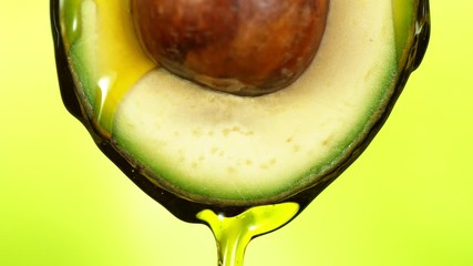Poster - Super slow motion of splashing oil on avocado slice. Filmed on high speed cinema camera.