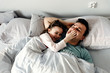 © Vadym - dad and daughter are smiling and smiling joyfully,father with a child after sleep fooling around in pajamas,dad tickles baby,a happy family,dad with daughter in the morning