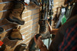 © Nomad_Soul - Man choosing boots for hunters in gun shop