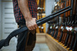 © Nomad_Soul - Male person with rifle at showcase in gun shop