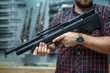© Nomad_Soul - Male person with pneumatic rifle in gun shop