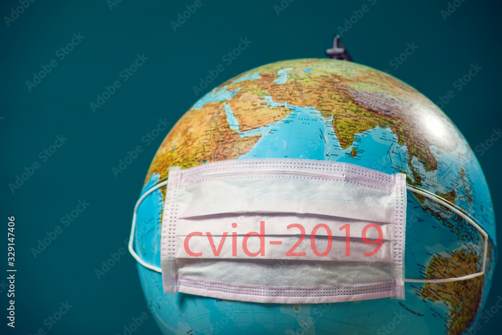Medicine  face mask with name of coronavirus covid-2019 on the globus. World epidemic of coronavirus.