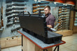 © Nomad_Soul - Man takes sniper rifle from the case in gun shop