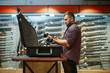 © Nomad_Soul - Man takes sniper rifle from the case in gun shop