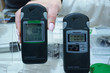 Customer hand holding personal dosimeter-radiometers for measuring levels of radiation