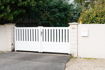 Wall Mural - modern gate in white aluminum with blades of suburbs house