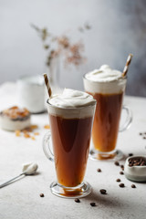 Iced coffee in a tall glasses with cream poured over