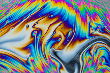 Wall Mural - psychedelic abstract background. photo macro shot with light interference on the surface of a soap b