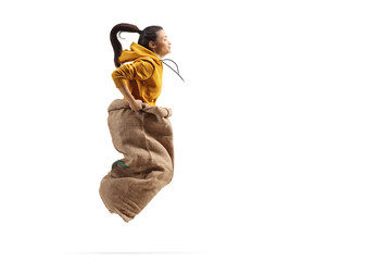 Poster - Young female jumping inside a sack