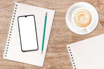 phone and coffee on a vintage wooden background. technology concept background. white screen phone c