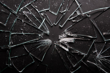 Broken glass on black background with lots of glass splinters