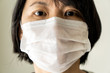 © Kenishirotie - Head to shoulder portrait of a China woman in a medical mask to protect from flu virus