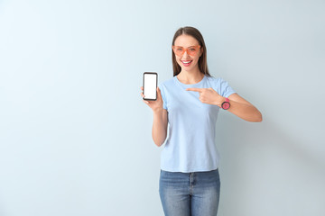 Sticker - Young woman with mobile phone on color background