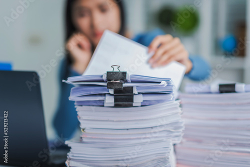 Fotomural Young employee woman hands checking stack of paper files for searching unfinished document arheieve after finish busy hard working