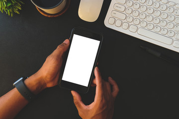 Cropped shot view of man hands holding smart phone with blank copy space screen for your text message or information content, female reading text message on cell telephone during in urban setting. 