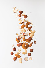 Flying Nuts On A Grey Background: Almonds, Cashew And Hazelnat