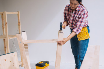 Wall Mural - woman worker in the carpenter workroom.