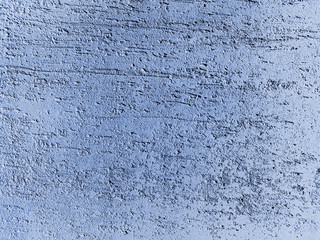 Blue stucco on the scratched wall surface. Painted putty. Decorative construction materials and colours. Abstract background texture pattern with copyspace